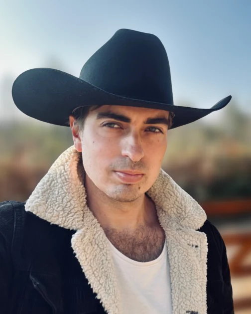 Country artist Estevan Knox in a black cowboy hat and sherpa jacket